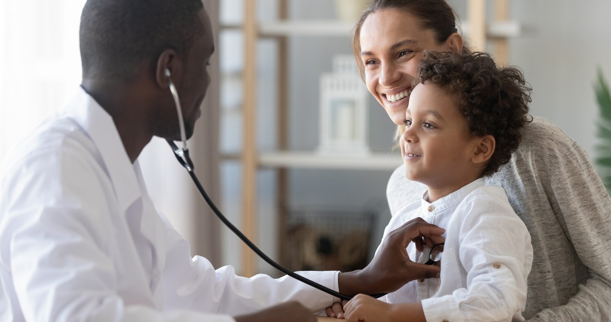 African male pediatrician hold stethoscope exam child boy patient visit doctor with mother, black paediatrician check heart lungs of kid do pediatric checkup in hospital children medical care concept